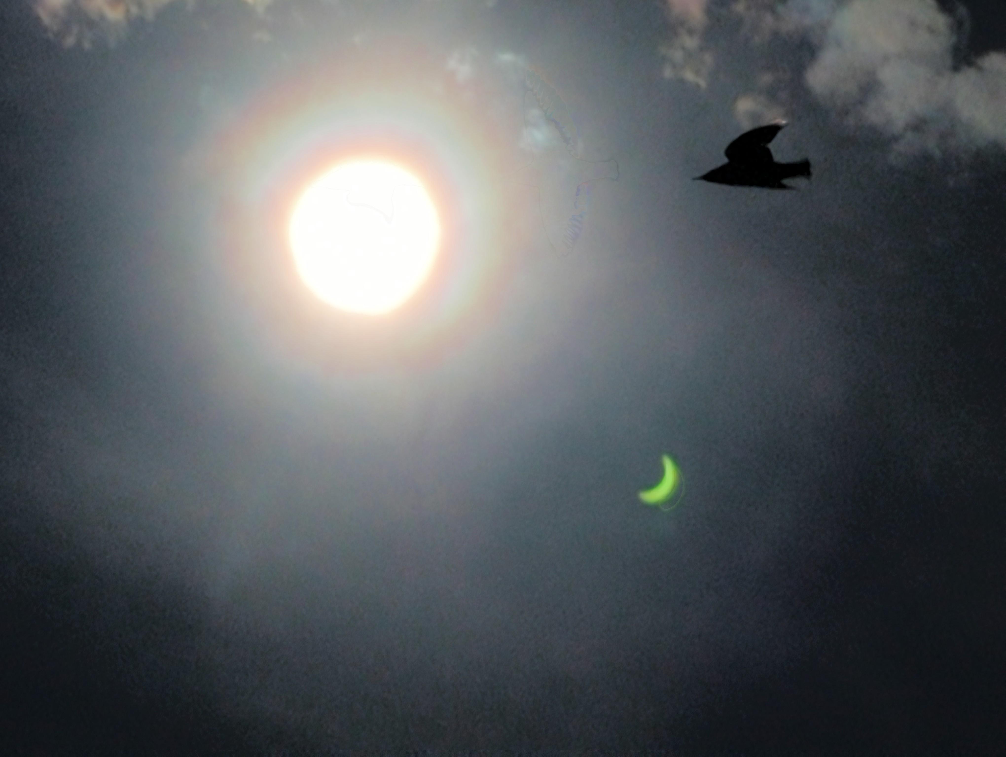 Eclipse photo of sun, cllouds, and sky